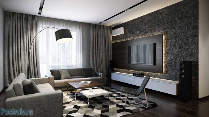 Черный, белый и серый цвета на ковре в интерьере гостиной. Фото